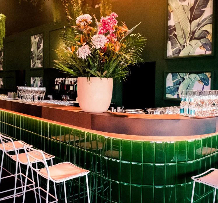 Ask us for your event with our bar Botaniets, full of flavors featuring a vibrant green bar setup.