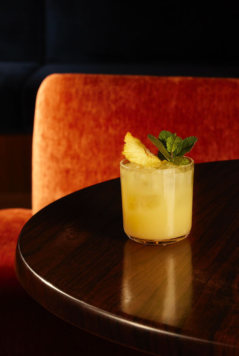 Refreshing non-alcoholic Mai Tai recipe served in a glass with pineapple garnish on a dark wooden table.